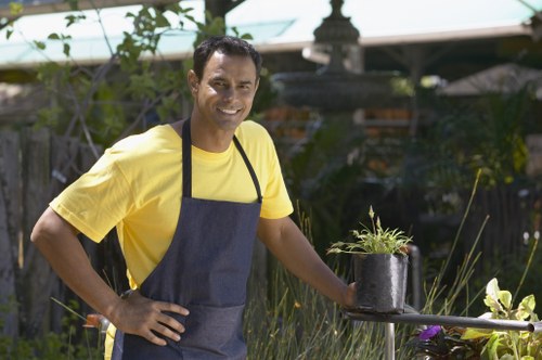 Gardener working on a small urban front garden in Brixton